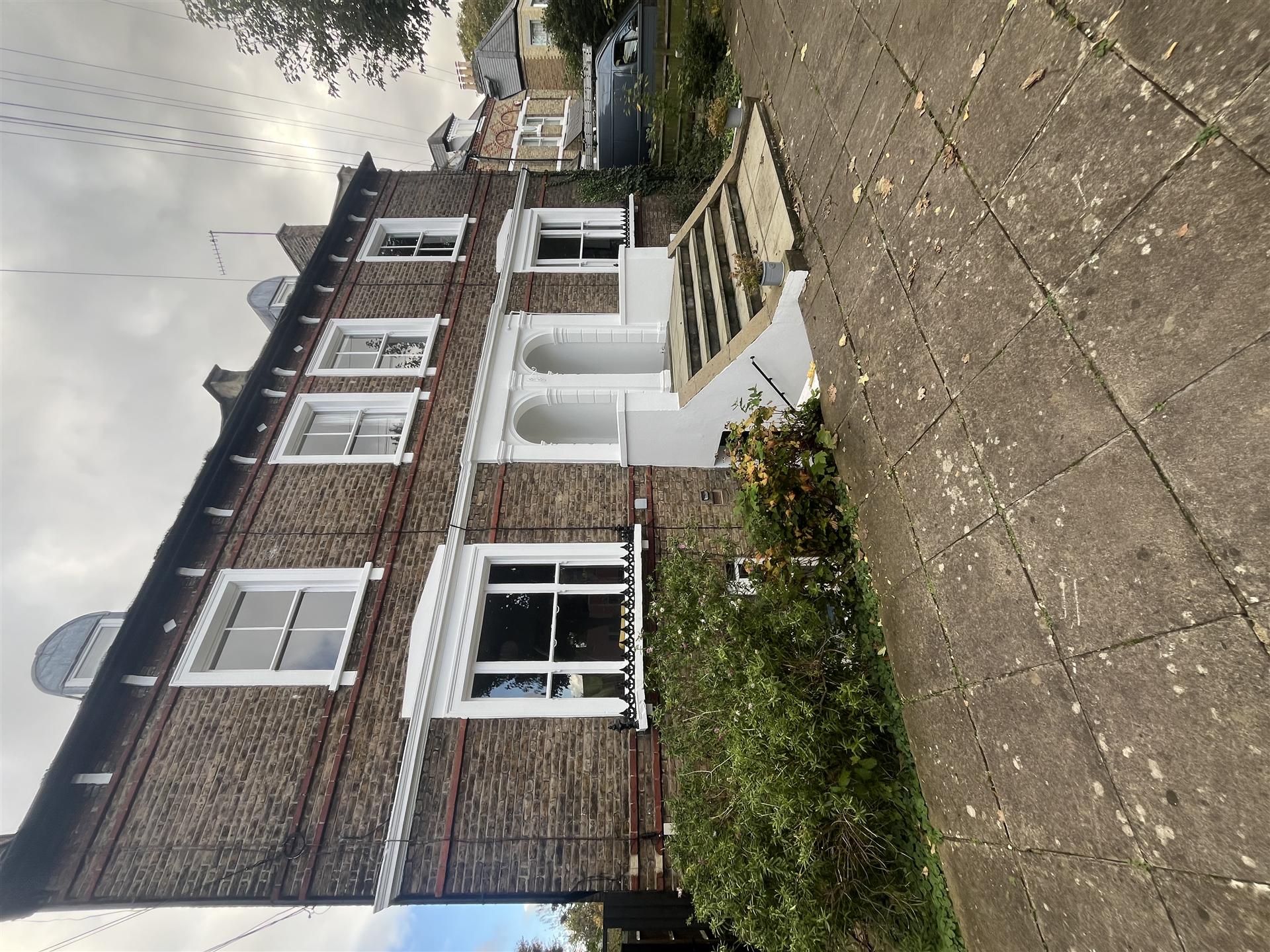 Brick terrace house with fresh white paintwork, Essex